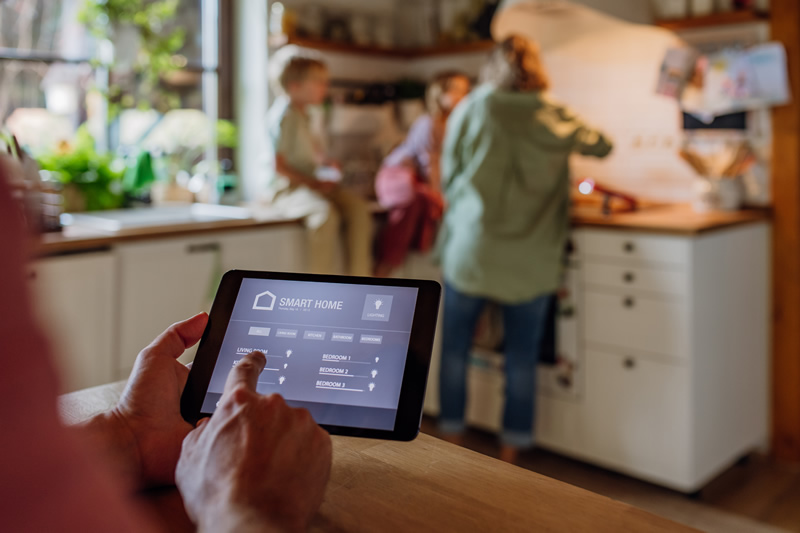 smart home technology. A person selecting options on a tablet.